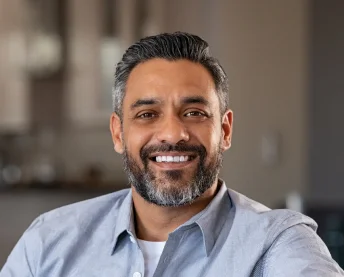 Patient smiling after dental implant care